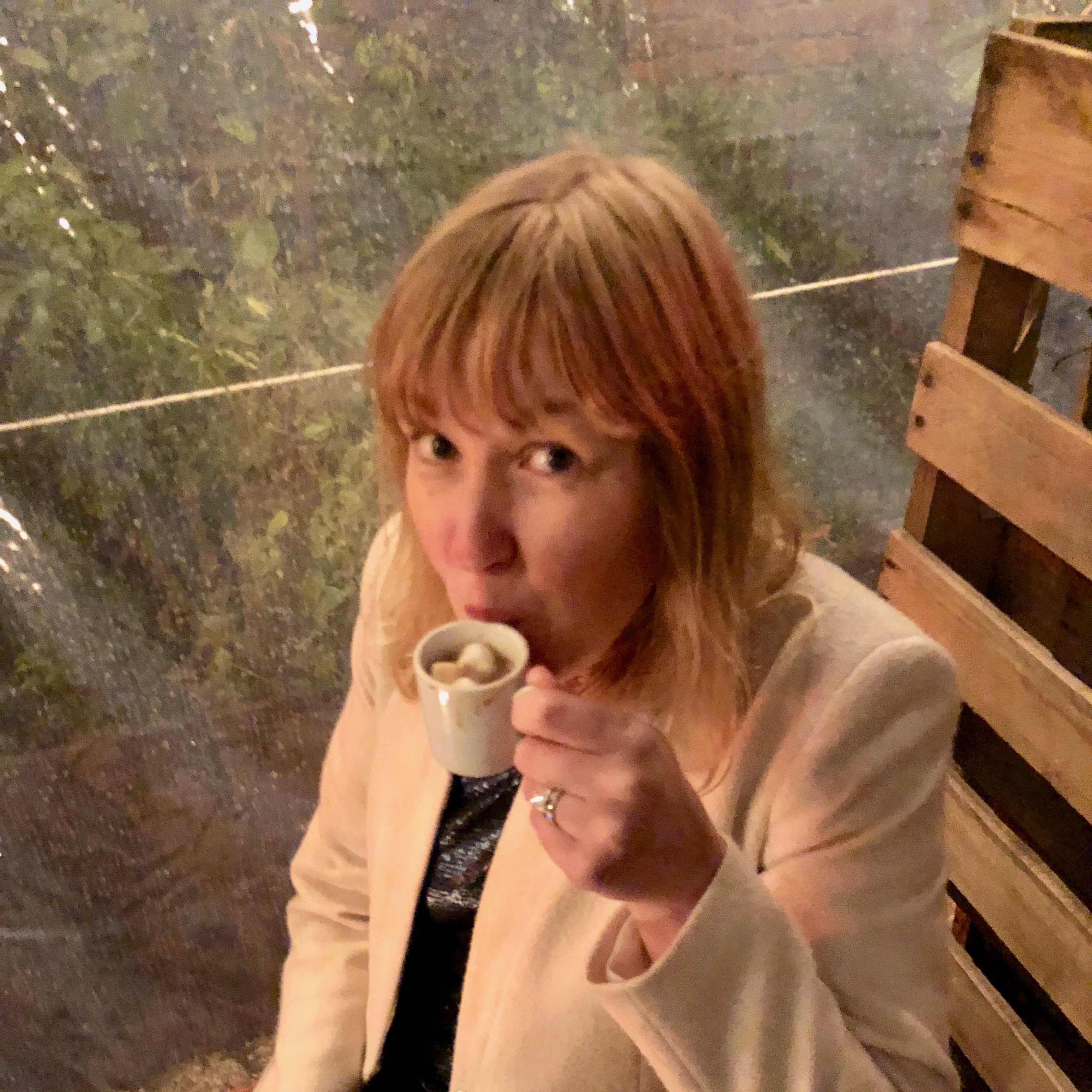 emily drinking hot chocolate from a tiny cup